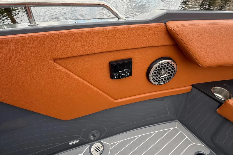 Slide: The Image of 2023 Cruisers Yachts 34 GLS OB interior with orange upholstery, speaker, and control panel. - 14