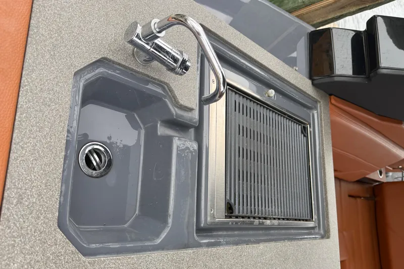 Slide: The Image of 2023 Cruisers Yachts 34 GLS OB boat sink and grill setup. - 17