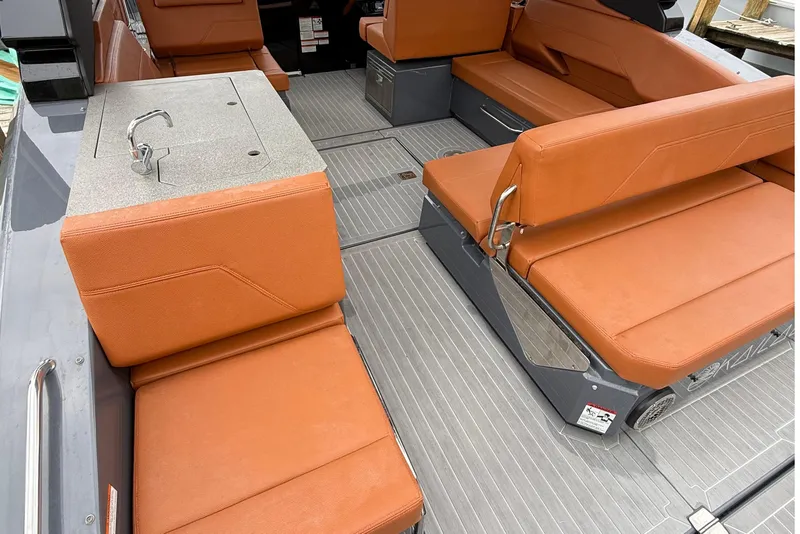 Slide: The Image of 2023 Cruisers Yachts 34 GLS OB interior with orange seating and sleek design. - 20