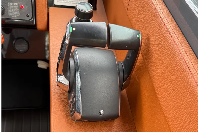 Slide: The Image of Throttle control of 2023 Cruisers Yachts 34 GLS OB on brown leather panel. - 23
