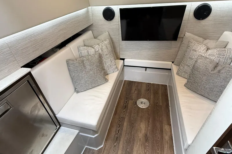 Slide: The Image of 2023 Cruisers Yachts 34 GLS OB interior with seating, TV, and modern decor. - 28
