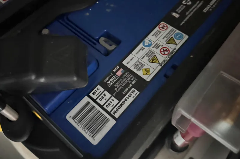 Slide: The Image of Battery compartment of 2023 Cruisers Yachts 34 GLS OB with safety labels and barcode. - 30