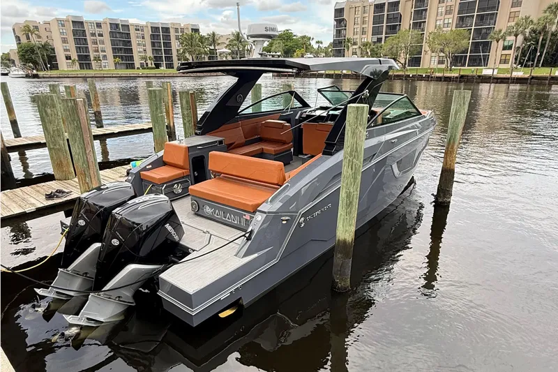 Slide: The Image of 2023 Cruisers Yachts 34 GLS OB docked, featuring sleek design and dual outboard engines. - 4