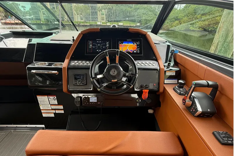 Slide: The Image of 2023 Cruisers Yachts 34 GLS OB helm with modern controls and navigation displays. - 6