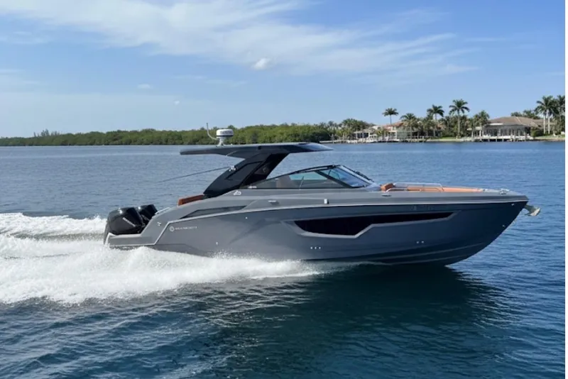 Slide: The Image of 2023 Cruisers Yachts 34 GLS OB cruising on a sunny day, showcasing sleek design. - 1