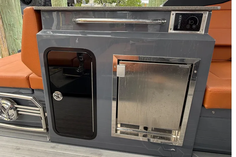 Slide: The Image of 2023 Cruisers Yachts 34 GLS OB interior with sleek cabinetry and stainless steel appliances. - 10