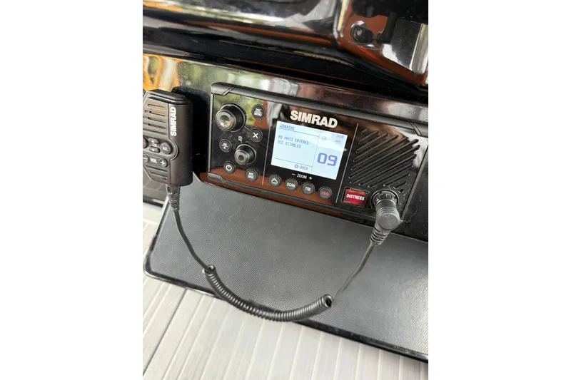 Slide: The Image of Simrad marine radio on 2023 Cruisers Yachts 34 GLS OB dashboard. - 24