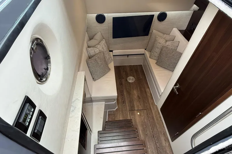 Slide: The Image of 2023 Cruisers Yachts 34 GLS OB cabin interior with modern seating and wood flooring. - 29