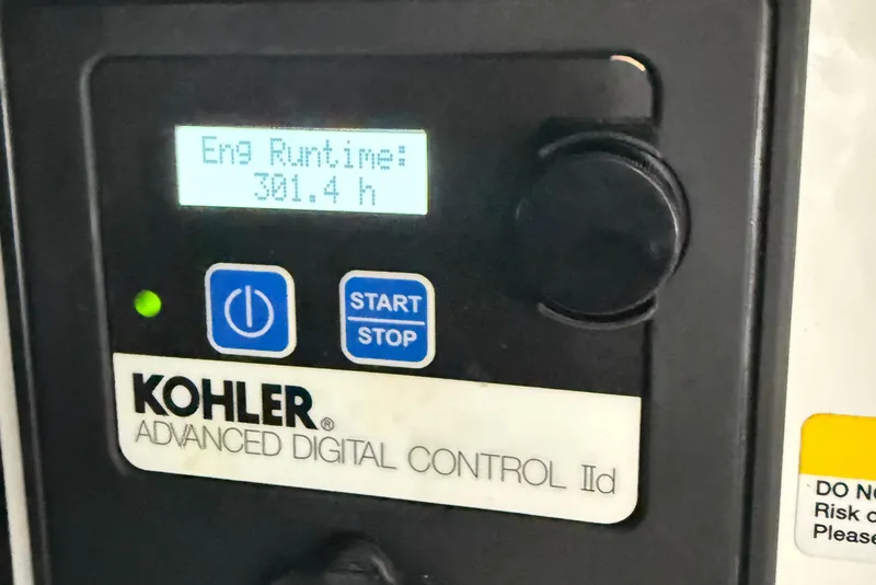 Slide: The Image of Kohler digital control panel showing engine runtime of 301.4 hours on 2023 Cruisers Yachts 34 GLS OB. - 36