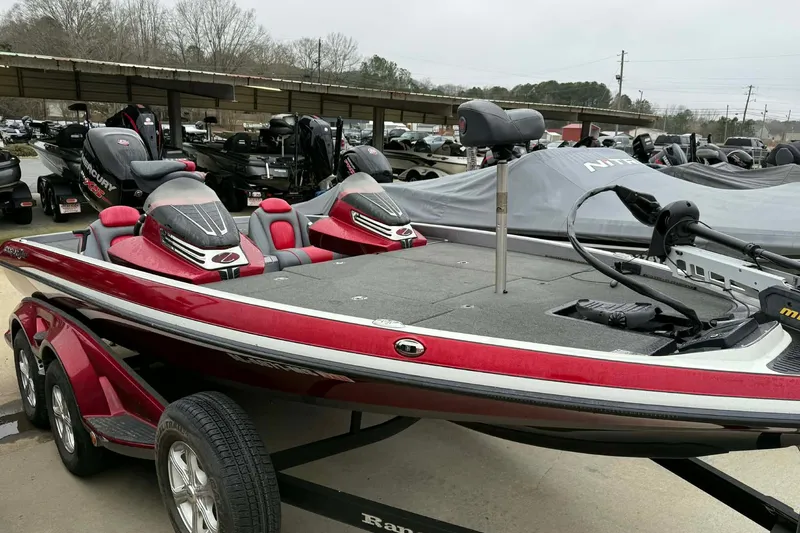 The Image of 2015 Ranger Z518 Comanche bass boat in red, parked on a trailer. - 0