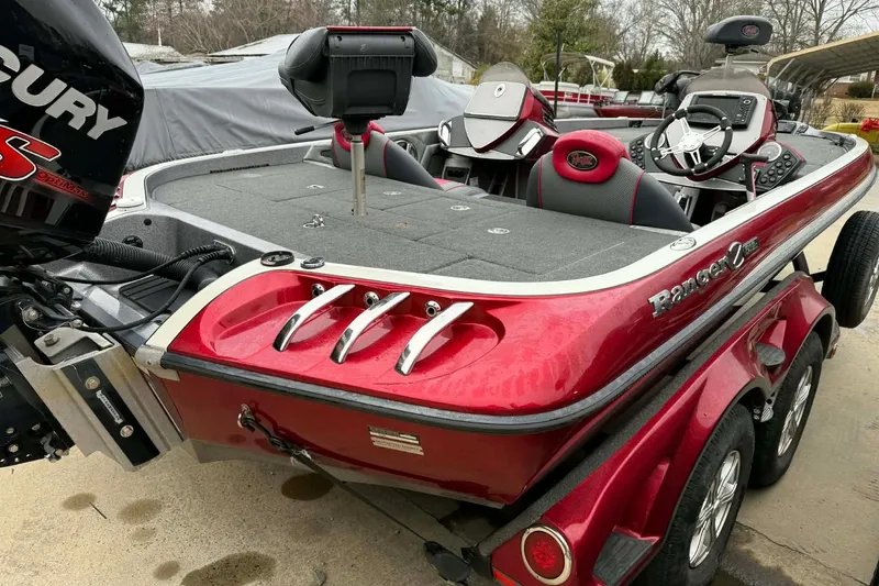 Slide: The Image of 2015 Ranger Z518 Comanche boat with Mercury engine, red exterior, and dual console design. - 8