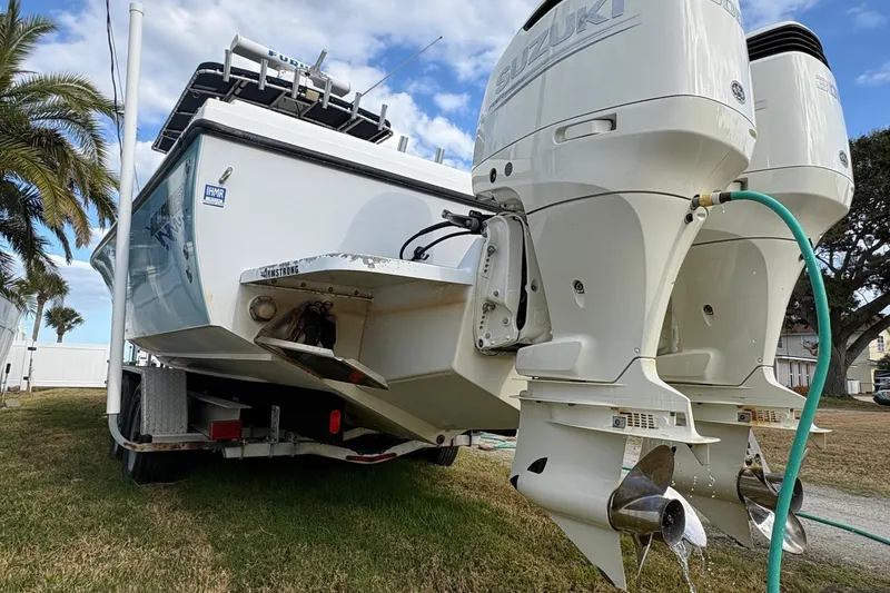 Slide: The Image of 2006 Bluewater 2850 CC boat with dual Suzuki outboard motors on a trailer. - 4
