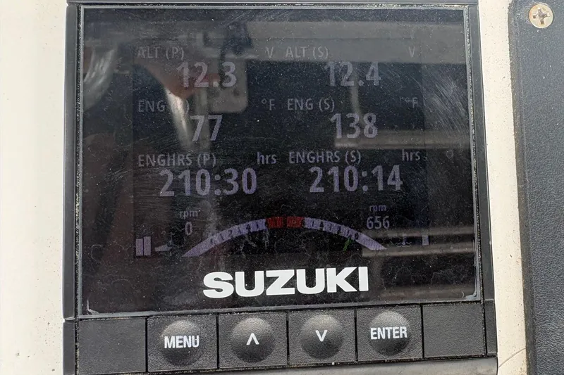 Slide: The Image of Suzuki engine display on 2006 Bluewater 2850 CC showing engine hours and temperature. - 8