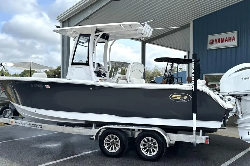 Slide: The Image of 2026 Sea Hunt Ultra 245 SE boat on trailer at Yamaha dealership. - 1