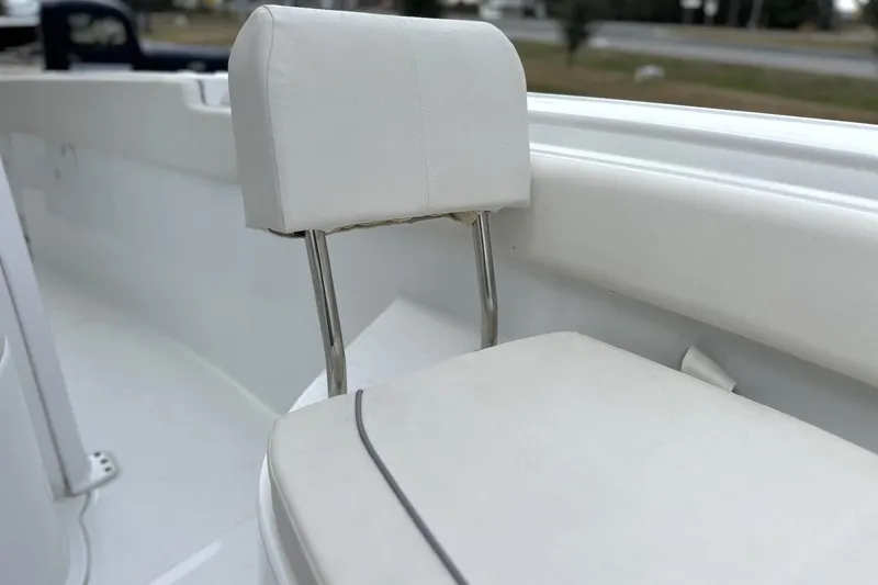 Slide: The Image of 2026 Sea Hunt Ultra 245 SE boat seat with white upholstery and stainless steel supports. - 11