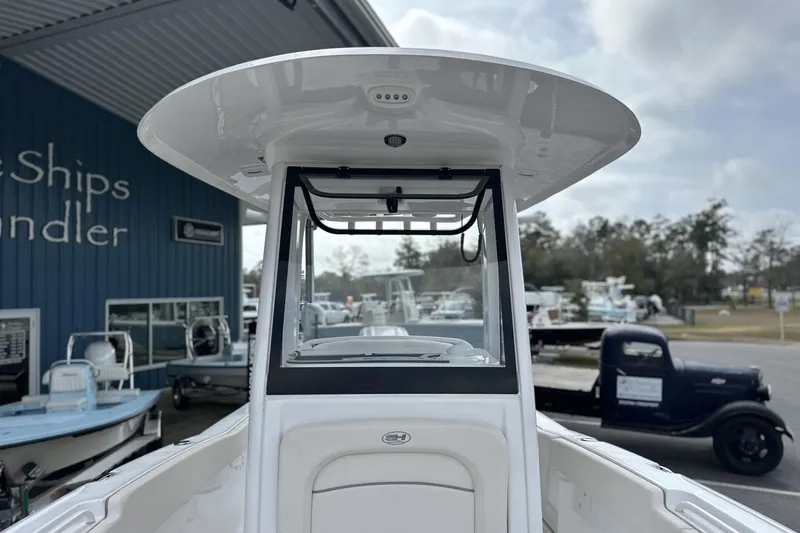 Slide: The Image of 2026 Sea Hunt Ultra 245 SE boat at a dealership, showcasing its sleek design. - 12