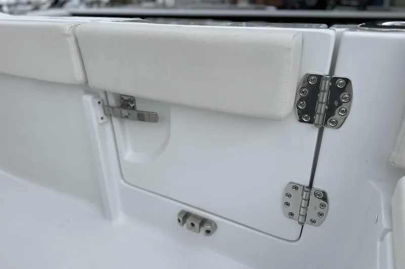 Slide: The Image of 2026 Sea Hunt Ultra 245 SE boat interior with stainless steel hinges and white cushioned seating. - 14