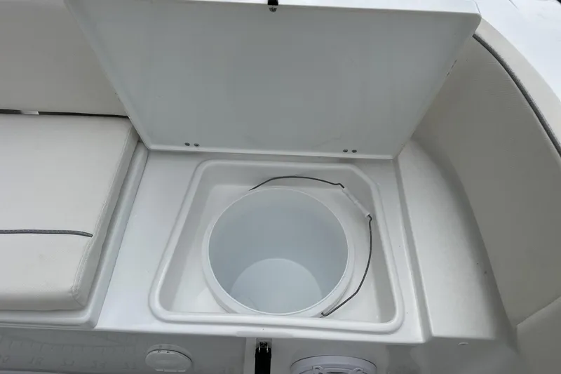 Slide: The Image of Livewell compartment on 2026 Sea Hunt Ultra 245 SE boat, open lid view. - 17