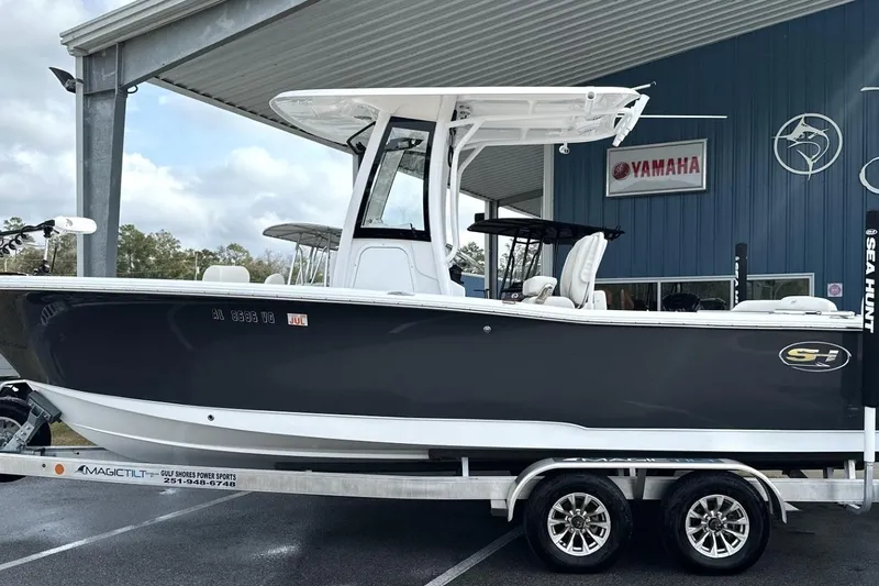 Slide: The Image of 2026 Sea Hunt Ultra 245 SE boat on trailer at dealership. - 23