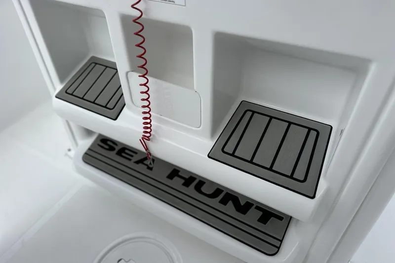 Slide: The Image of 2026 Sea Hunt Ultra 245 SE boat interior with branded step and safety cord. - 7