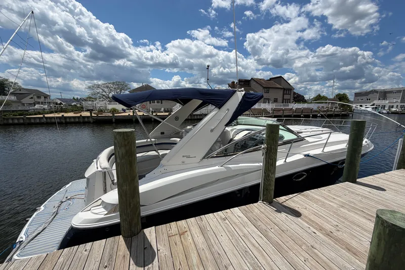 Slide: The Image of 2006 Monterey 350 Sport Yacht docked under a partly cloudy sky. - 22