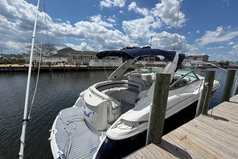 Slide: The Image of 2006 Monterey 350 Sport Yacht docked under a partly cloudy sky. - 23