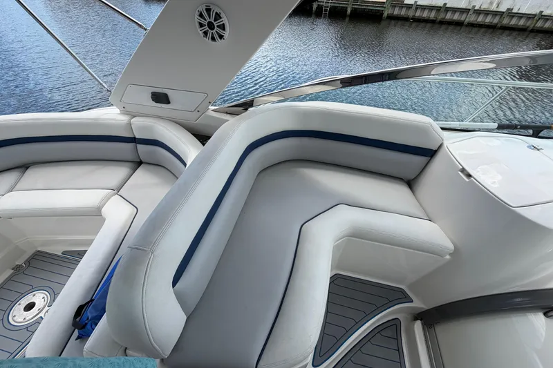 Slide: The Image of 2006 Monterey 350 Sport Yacht interior with white seating and blue accents by the water. - 32