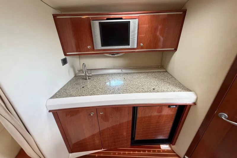 Slide: The Image of 2006 Monterey 350 Sport Yacht interior kitchen with wood cabinets and granite countertop. - 34
