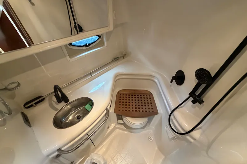 Slide: The Image of Bathroom interior of 2006 Monterey 350 Sport Yacht with sink, shower, and wooden seat. - 35