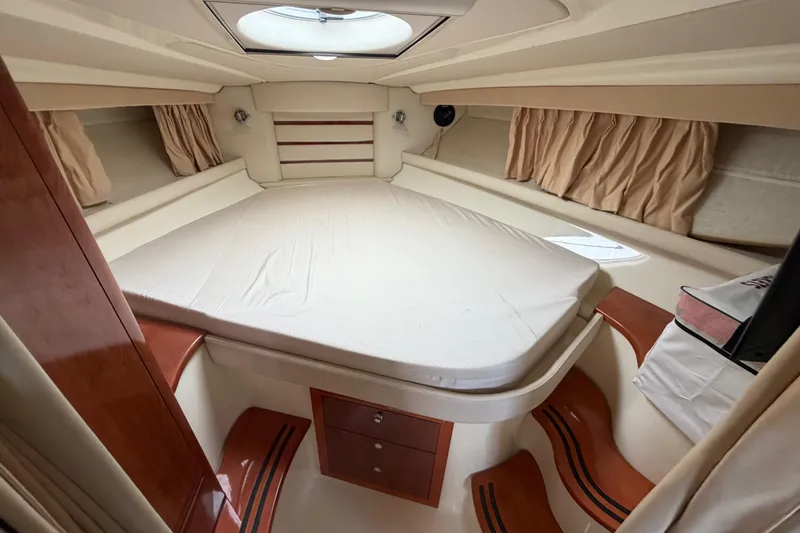 Slide: The Image of Luxurious cabin interior of 2006 Monterey 350 Sport Yacht with cozy bed and elegant wood accents. - 36