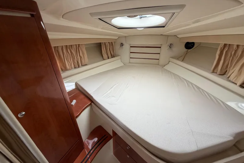 Slide: The Image of Luxurious cabin interior of a 2006 Monterey 350 Sport Yacht with a skylight and wood accents. - 37