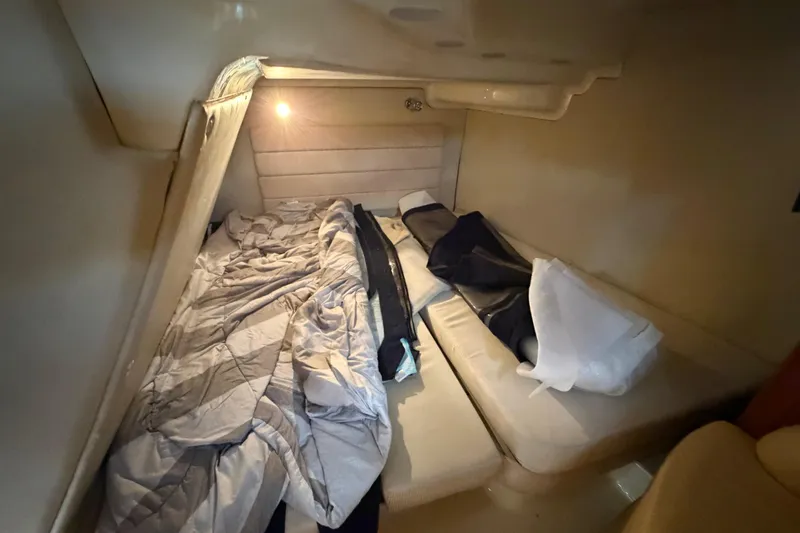 Slide: The Image of Cozy cabin interior of 2006 Monterey 350 Sport Yacht with bedding and soft lighting. - 39