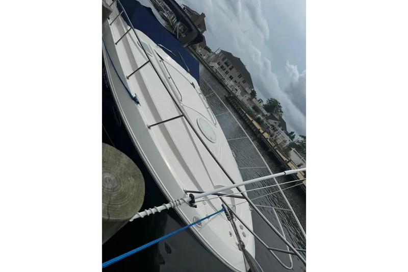 Slide: The Image of 2006 Monterey 350 Sport Yacht docked at marina, overcast sky. - 4