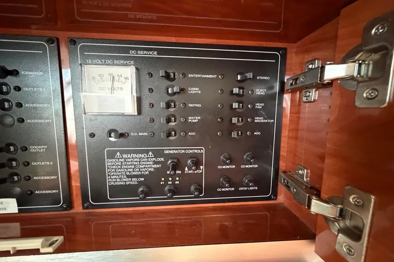 Slide: The Image of Control panel of a 2006 Monterey 350 Sport Yacht, featuring DC service switches and voltage meter. - 41