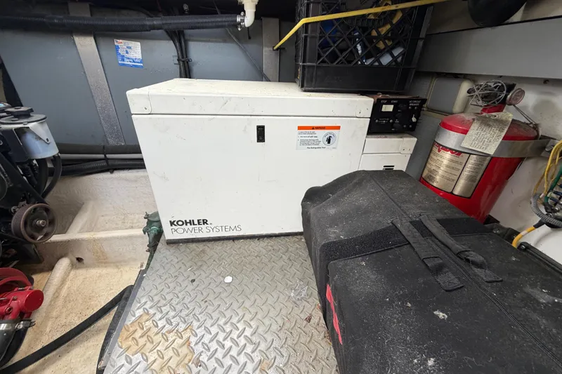 Slide: The Image of Engine room of 2006 Monterey 350 Sport Yacht with Kohler power system and fire extinguisher. - 47