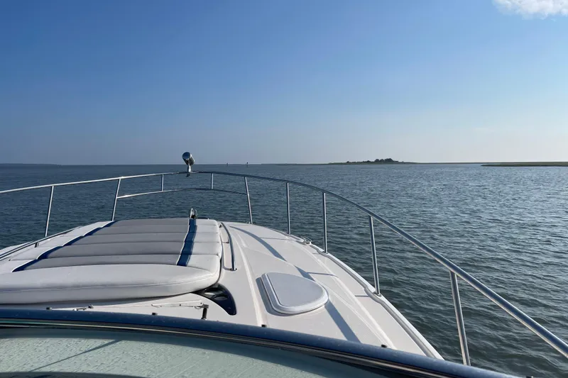 Slide: The Image of 2006 Monterey 350 Sport Yacht cruising on calm waters under clear blue sky. - 6
