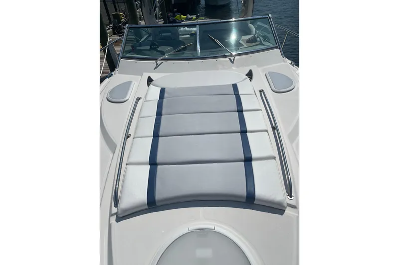 Slide: The Image of 2006 Monterey 350 Sport Yacht with sunpad on deck, docked by the water. - 7