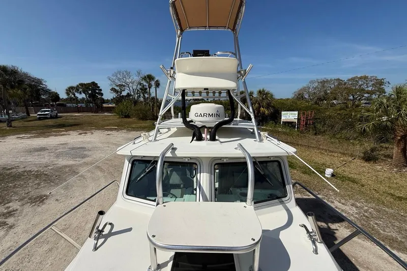 Slide: The Image of 2019 Parker 2520 XLD Sport Cabin boat with Garmin radar, parked outdoors. - 10