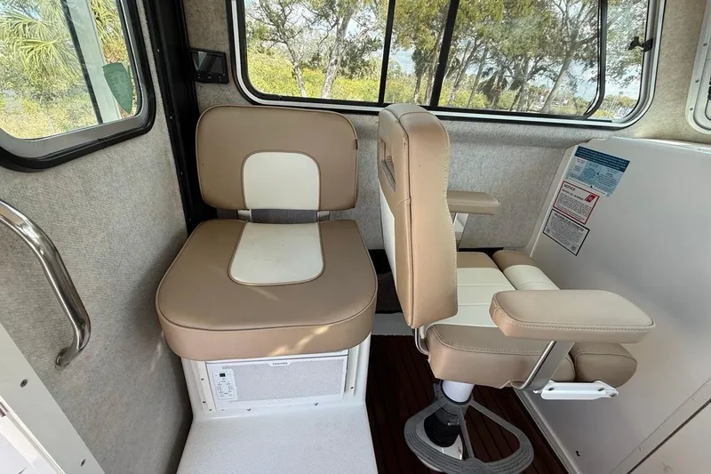 Slide: The Image of Interior of 2019 Parker 2520 XLD Sport Cabin with beige seating and windows. - 15