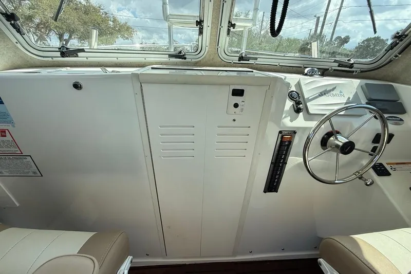 Slide: The Image of 2019 Parker 2520 XLD Sport Cabin interior with steering wheel and navigation equipment. - 17