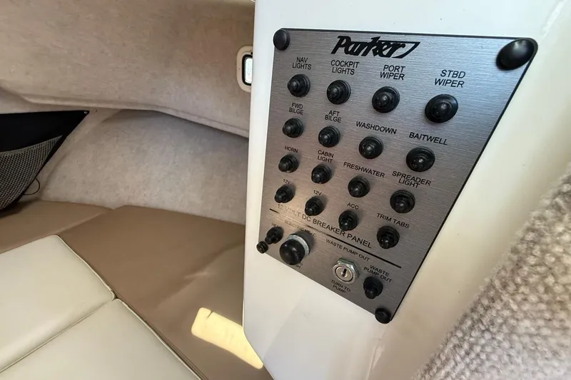 Slide: The Image of Control panel inside 2019 Parker 2520 XLD Sport Cabin boat, featuring various switches and labels. - 19