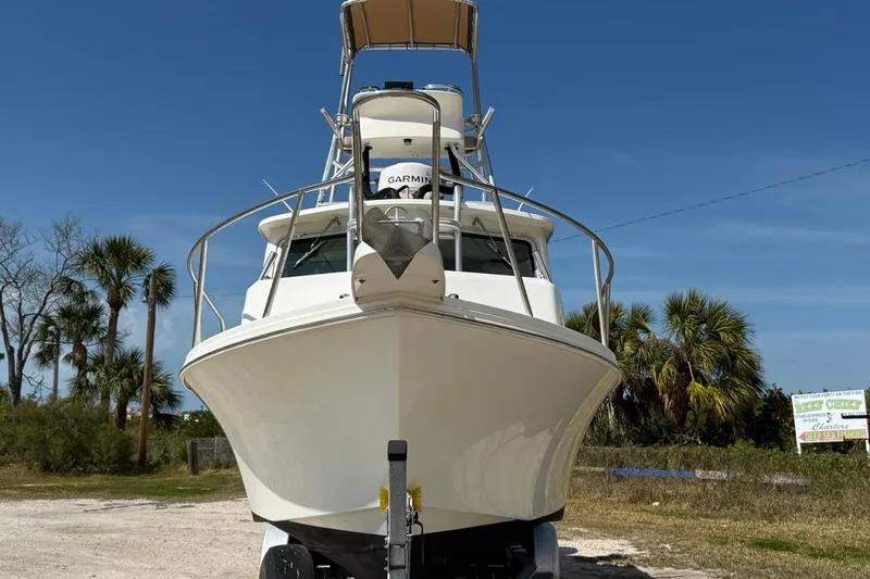 Slide: The Image of 2019 Parker 2520 XLD Sport Cabin boat on trailer, clear sky background. - 2