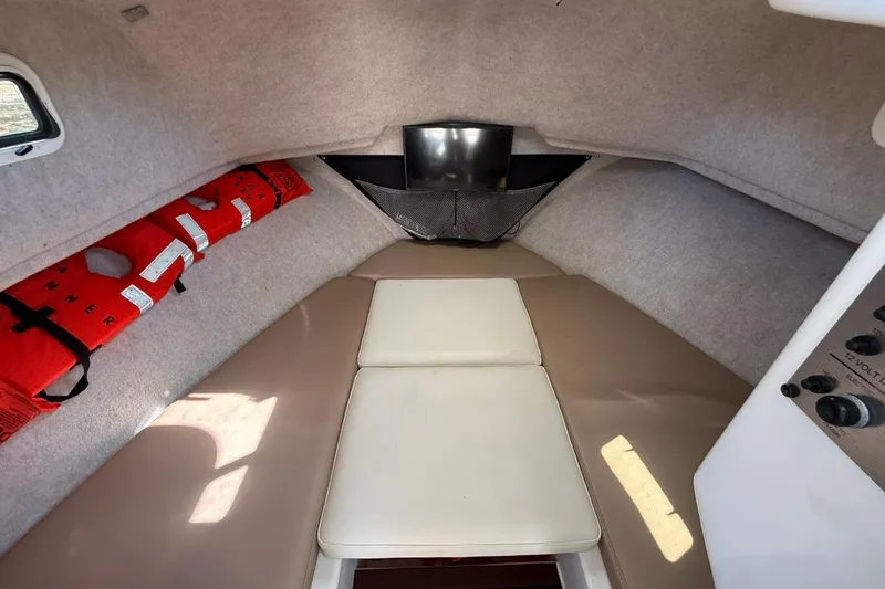Slide: The Image of 2019 Parker 2520 XLD Sport Cabin interior with life jackets and cushioned seating. - 20