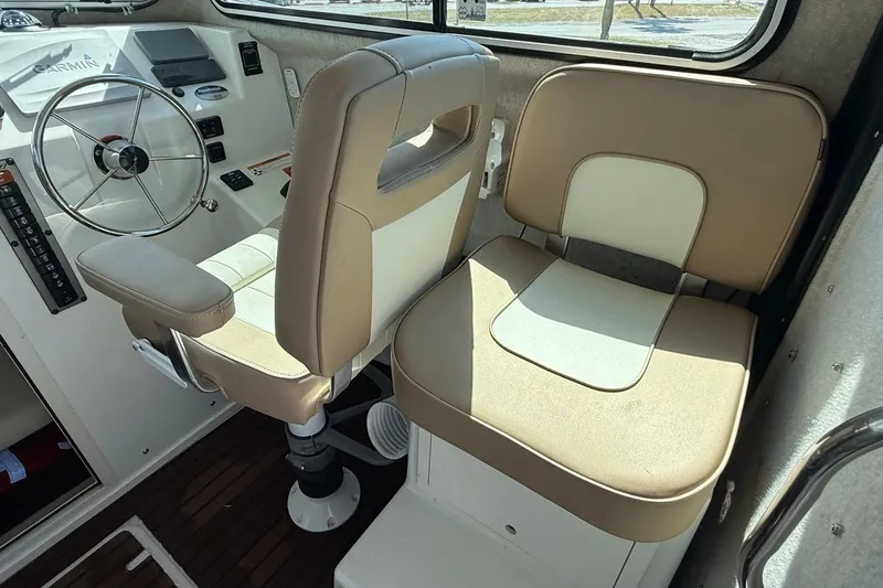 Slide: The Image of 2019 Parker 2520 XLD Sport Cabin interior with steering wheel and beige seating. - 23