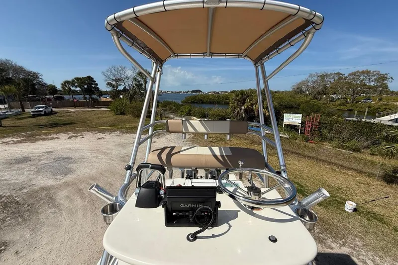 Slide: The Image of 2019 Parker 2520 XLD Sport Cabin boat with Garmin navigation, parked near a scenic waterfront. - 29