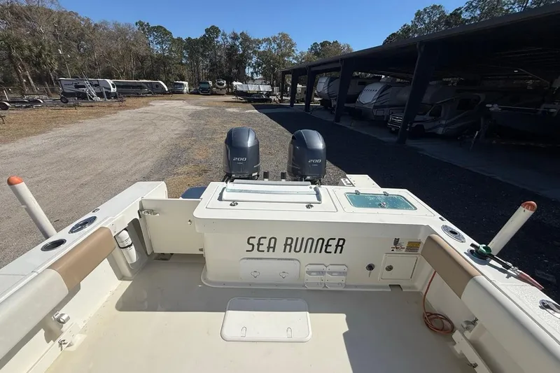 Slide: The Image of 2019 Parker 2520 XLD Sport Cabin boat with twin engines in a storage area. - 31