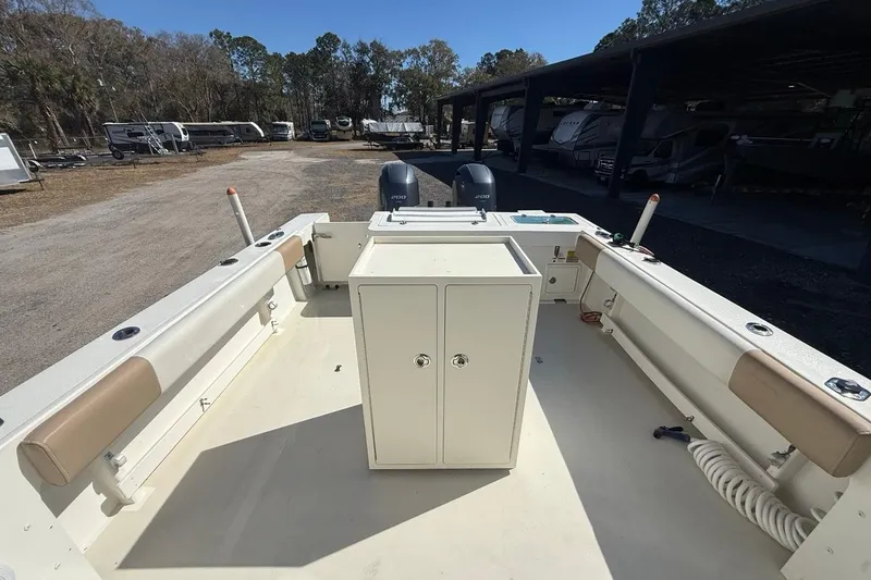Slide: The Image of 2019 Parker 2520 XLD Sport Cabin boat interior with storage and seating. - 32