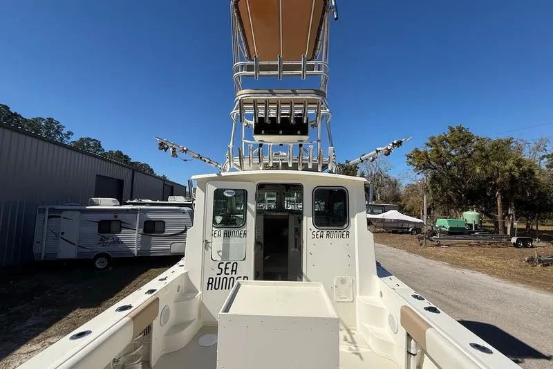 Slide: The Image of 2019 Parker 2520 XLD Sport Cabin boat with tower, parked outdoors. - 34