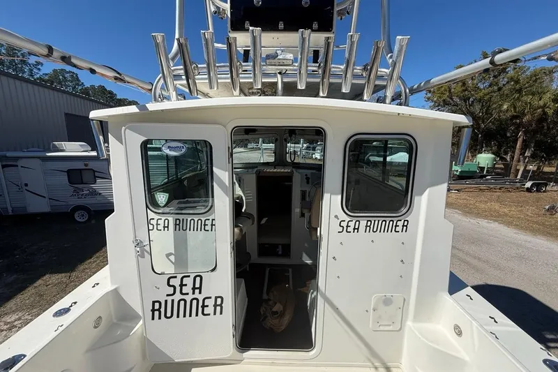 Slide: The Image of 2019 Parker 2520 XLD Sport Cabin boat, "Sea Runner," with open cabin door. - 35