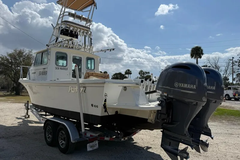 Slide: The Image of 2019 Parker 2520 XLD Sport Cabin boat with twin Yamaha engines on a trailer. - 5
